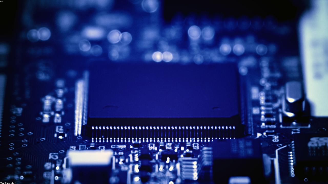 Semiconductor wafer reflecting industrial blue light.