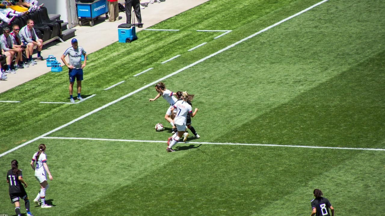 Women's professional soccer match with crowded stadium stands.